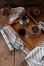 A cup of coffee on a wooden tray. Turk and coffee beans. Cook breakfast at home. Still life with a drink in a glass. Ground coffee