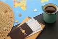 Cup of coffee, world map and passport with air tickets on table. Travel concept