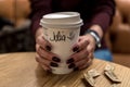 Cup of coffee with writen word JULIA in woman hand Royalty Free Stock Photo