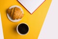 Cup of coffee on yellow background.