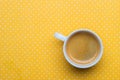 A Cup Of Coffee On A Yellow Polka Dot Background