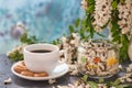 Cup of coffeel and acacia closeup.