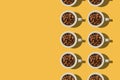 Cup concept. White cups with coffee beans on yellow background.