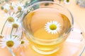 Cup with decoction of chamomile on a yellow background Royalty Free Stock Photo