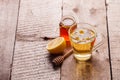 Cup of delicious camomile tea, lemon and honey on wooden table. Seasonal flu cold alternative medicine remedy Royalty Free Stock Photo