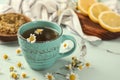 Cup of delicious camomile tea on light table, closeup Royalty Free Stock Photo