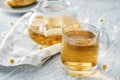 Cup of delicious camomile tea on wooden table, closeup Royalty Free Stock Photo