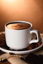 Cup of delicious hot chocolate, spices and coffee beans on table Royalty Free Stock Photo