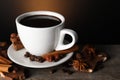 Cup of delicious hot chocolate, spices and coffee beans on wooden table Royalty Free Stock Photo