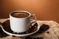 Cup of delicious hot chocolate, spices and coffee beans on table. Space for text Royalty Free Stock Photo