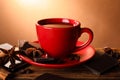 Cup of delicious hot chocolate, spices and coffee beans on wooden table Royalty Free Stock Photo