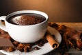 Cup of delicious hot chocolate, spices and coffee beans on wooden table Royalty Free Stock Photo