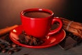 Cup of delicious hot chocolate, spices and coffee beans on wooden table Royalty Free Stock Photo