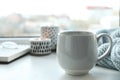 Cup of delicious hot winter drink on window sill Royalty Free Stock Photo