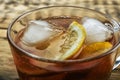 Cup of delicious iced tea on wooden table