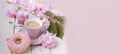 cup with drink coffee cappuccino, hot chocolate with milk, sakura flowers, caffeine improves functioning of human brain,