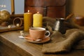 cup with drink coffee on old vintage wooden table, metal coffee maker, candles burn, caffeine improves functioning of human brain Royalty Free Stock Photo