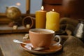 cup with drink coffee on old vintage wooden table, metal coffee maker, candles burn, caffeine improves functioning of human brain Royalty Free Stock Photo