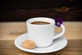 Cup of espresso with biscotti on wooden table