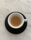 Cup of espresso black saucer marble like table