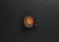 Cup with espresso on a black stone background, copy space for text. Top view. Coffee time