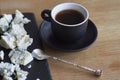 Cup of espresso and black board with pieces of blue cheese on wooden table, perfect breakfast concept, selective focus