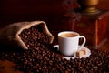Cup of espresso with coffee beans on wooden table Royalty Free Stock Photo