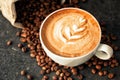 Cup of espresso with coffee beans spilled around it Royalty Free Stock Photo