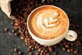 Cup of espresso with coffee beans spilled around it Royalty Free Stock Photo