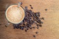 Cup of Espresso coffee and coffee beans on wooden background.