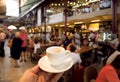 Cup of espresso coffee in huge space of modern market with bars, tables and fast-food stores, Florence, Italy