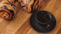 Cup of espresso coffee and pair of traditional Peruvian maracas made from gourd on a vintage wooden table.