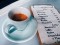 Cup of espresso coffee ready to serve with coffee menu on the blue table in the coffee shop. vintage photo and film style Royalty Free Stock Photo