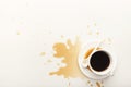 Coffee cup and spilt espresso on white background Royalty Free Stock Photo