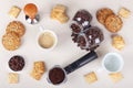 Cup of espresso, crackers, cookies, holder with ground coffee, tamper and cans of coffee beans on table. View from above Royalty Free Stock Photo