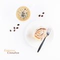 Cup of espresso and fresh cinnabon roll with glaze on white background. Homemade cinnamon bun and coffee. Top view Royalty Free Stock Photo