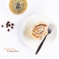 Cup of espresso and fresh cinnabon roll with glaze on white background. Homemade cinnamon bun and coffee. Top view Royalty Free Stock Photo