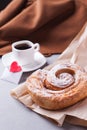 A cup of espresso on a saucer and a layered bun - a classic European or North American breakfast and a love letter in an envelope. Royalty Free Stock Photo