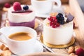 Cup of espresso with sweet cakes with berries on table Royalty Free Stock Photo