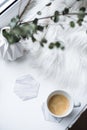 Cup of espresso on white table with cozy interior details Royalty Free Stock Photo