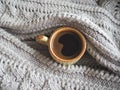 A Cup of espresso in a winter sweater. The concept of home comfort, coziness and warmth. Royalty Free Stock Photo