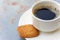 Cup filled with black coffee on saucer with brown biscuit Royalty Free Stock Photo