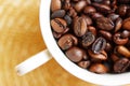 Cup filled with freshly roasted coffee beans Royalty Free Stock Photo