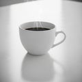 Cup filled with steaming black coffee sits on a smooth, light-color Royalty Free Stock Photo