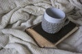 Cup with a flavored drink, stands on a book with a plaid