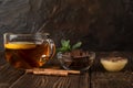 A Cup of fragrant black tea with lemon and milk chocolate with mint and honey. Royalty Free Stock Photo