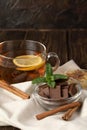 A Cup of fragrant black tea with lemon and milk chocolate with mint and honey. Royalty Free Stock Photo