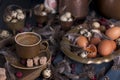 A cup of fragrant coffee and brown sugar. Vintage photo. Eggs chicken and quail and feathers. Easter. Photo in a rustic style.