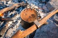Cup of fragrant coffee with foam on a campfire, tourist morning Royalty Free Stock Photo