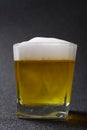 cup of fresh beer on dark background Royalty Free Stock Photo